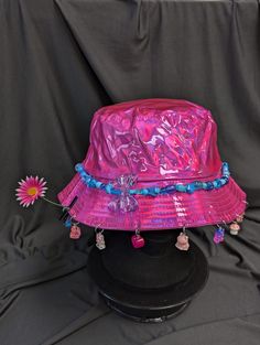 -hat color - pink -bead color -blue -charm color - blue and pink -unisex adult size -inner circumference - 22.5in -crown dip - 3in -brim - 2.25in -NOT machine washable -Perfect for raves and outdoor festivals! Shipping within the US USPS First Class Package 3-9 days USPS Priority Mail 1-5 days USPS Priority Mail Express 1-3 days Shipping International  USPS First Class Mail International  -Varies- USPS Priority Mail International 6-14 days USPS Priority Mail Express International 3-9 days Shipping times are estimated, NOT GUARENTEED.  +International buyers are responsible for all import fees+ +Orders of $50+ may require signature confirmation upon delivery+ Cheap Multicolor Festival Hats, Luxury Blue Festival Hat, Pink Wide Brim Mini Hat For Festival, Fun Pink Hat, One Size, Pink Mini Hat For Festivals, Pink Wide Brim Hat For Festival, Fun Pink Adjustable Bucket Hat, Pink Wide Brim Festival Hat, Pink Adjustable Bucket Hat With Short Brim