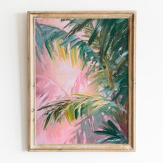 a painting hanging on the wall with palm trees