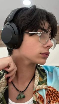 a young man wearing headphones on his neck