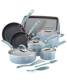 an assortment of blue pots and pans with utensils in front of them