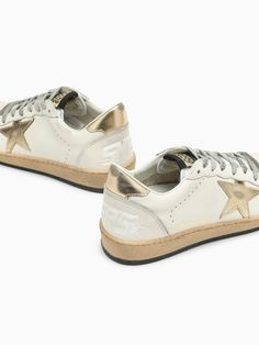 Elevate your sneaker game with these luxurious low top trainers, crafted from smooth milk-coloured leather with exquisite metallic detailing. The iconic star stitched on the side adds a touch of vintage charm, while the perforated round toe and lace-up fastening ensure both style and comfort. Complete with a stitched logo tab and a vintage-effect finish, these trainers are a must-have for the fashion-forward individual who appreciates the finer details. Whether you're pairing them with your favo Hermes Birkin 25, Every Step You Take, Versace Bags, Birkin 25, Sneaker Games, Designer Handbag, Balenciaga Designer, Colored Leather, Diaper Backpack