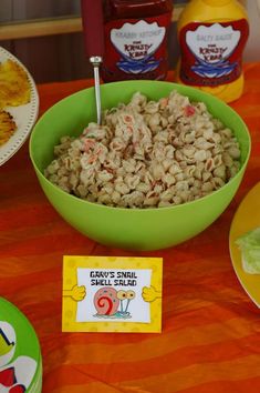 a bowl of food sitting on top of a table next to other plates and condiments