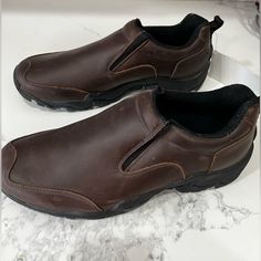 Never Worn, But Needs A Brief Cleaning. See All Photos. Noticeable Scuff On Shoe And Tag Still Included. Comes New In Box. Brown Leather Slip-on Outdoor Shoes, Masculine Brown Slip-on Leather Shoes, Brown Moc Toe Slip-ons For Outdoor, Brown Round Toe Loafers For Outdoor, Masculine Brown Plain Toe Slip-ons, Brown Slip-on Walking Shoes With Slip-resistant Sole, Brown Slip-on Loafers For Walking, Brown Cushioned Outdoor Loafers, Brown Moc Toe Loafers For Outdoor