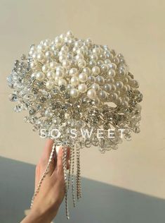 a hand holding a bunch of pearls in it's center with the words so sweet on it