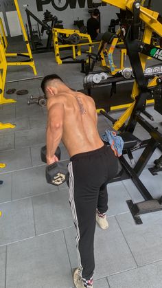 a man with no shirt in a gym