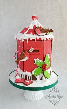 a red birdhouse decorated with christmas decorations