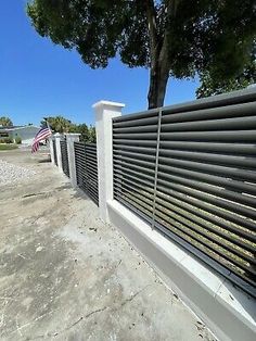 a white fence with an american flag in the background