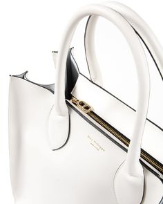 As worn by Kris Jenner, The Dee Holdall Tote elevates the expectations of a tote bag. Featuring a removable interior pocket and removable shoulder strap, this tote is as good at multitasking as you are. The structured silhouette and timeless 100% fine Italian leather make this tote a classic addition to every outfit. White Made in Italy 100% Leather Measures (Width-Height-Depth): 36x34x18 cm Timeless Tote Bag With Handles, White Satchel With Zipper Closure For Office, Timeless White Satchel For Office, Luxury Satchel With Zipper Closure For Shopping, Timeless Satchel With Detachable Strap For Shopping, Luxury White Satchel With Zipper Closure, Timeless White Bag With Handle Drop, Timeless White Satchel For Daily Use, Elegant White Satchel With Zipper Closure