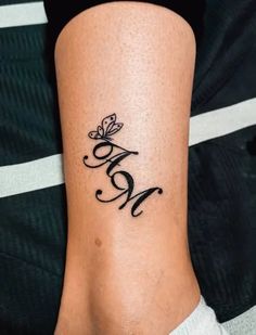 a woman's lower leg with a butterfly tattoo on it