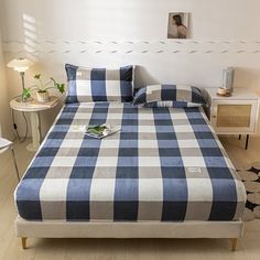 a blue and white checkered bedspread on a bed with two nightstands