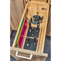 an open drawer with utensils in it