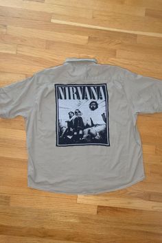 One-of-a-kind Short Sleeve Button-up featuring the band, Nirvana!  Thrifted and Prewashed 98% cotton & 2% Spandex button-up with thrifted t-shirt print stitched to the back.   Size 3X-Large  Measurements: ♥  Shoulders: 22.75" ♥  Chest: 30" ♥  Sleeve: 11.5" ♥  Length: 27.5" . . . . . . . . . . . . . . . . . . . . . . . . . . . . . . . . . . . . . . . . . . . . . Handmade ♥ Thrifted ♥ Recycled ♥ Upcycled These shirts are created with button-ups and shirts that need a second life and once they are combined they become unique one of a kind items!  The shirts are MEN'S sizes but can be worm by both men and women!  For a more baggy, comfy, and oversized fit, order a size up from your regular size. . . . . . . . . . . . . . . . . . . . . . . . . . . . . . . . . . . . . . . . . . . . . . If you ha Oversized Cotton Button-up Camp Shirt, Vintage Buttoned Tops For Streetwear, Cotton Button-up Tops For Festival, Vintage Graphic Print Camp Shirt For Streetwear, Vintage Camp Shirt With Relaxed Fit For Streetwear, Vintage Relaxed Fit Camp Shirt For Streetwear, Festival Cotton Button-up Shirt, Cotton Button-up Festival Shirt, Casual Festival Tops With Pockets