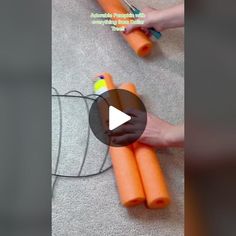 someone is holding carrots on the floor with their feet and thumbnails pointing at them