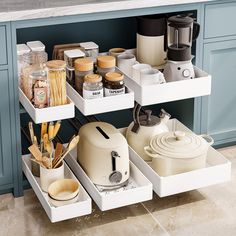 an organized kitchen drawer with pots and pans