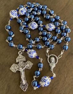 "This beautiful handmade rosary is made with 8mm blue glass, 10mm ceramic beads and 2\" Pardon crucifix. Length: 20\" inches long" Blue Rosary With 8mm Beads In Cross Shape, Blue Rosary With 8mm Beads And Crucifix, Adjustable Blue Rosary With 8mm Beads, Handmade Blue Rosary With Cross, Handmade Blue Rosary With Cross Shape, Beautiful Rosaries, Catholic Wallpaper, Rosary Jewelry, Holy Rosary