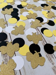 mickey mouse cut outs on a wooden table with yellow and black circles around them for decoration