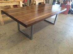 a wooden table with metal legs in a shop