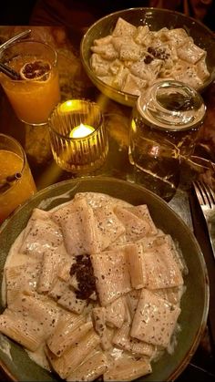 a table topped with plates of food next to glasses of juice and orange juices