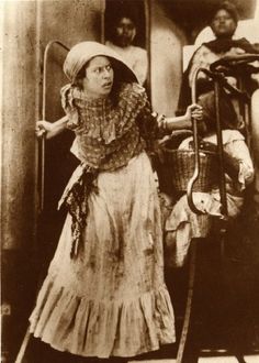 an old black and white photo of a woman with crutches