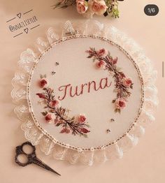 a white doily with the word june written on it next to a pair of scissors