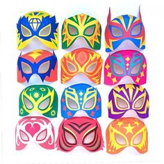 a group of colorful masks sitting on top of a white table next to each other