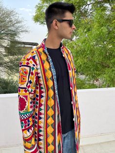 Long Boho Patchwork Embroidered Festival Coat from AlMiro Wearing art literally on your sleeve. A stunning upcycled coat, handmade from authentic tribal Indian Banjara vintage fabric. This fabric was created by the ancient nomadic tribes of north India. READY TO SHIP SIZE The coat shown here is ready to ship in the following measurements: ⚬ Chest: 38 inch ⚬ Length: 49 inch ⚬ Shoulder: 19 inch ⚬ Sleeve length: 25 inch ⚬ Size : XS/S With a hand embroidered design, two side pockets and side slits, Traditional Multicolor Cotton Outerwear, Festival Multicolor Cotton Outerwear, Fitted Cotton Outerwear For Festivals, Fitted Multicolor Outerwear For Festivals, Multicolor Motif Outerwear For Festivals, Multicolor Folk Style Cotton Outerwear, Multicolor Cotton Folk Outerwear, Multicolor Folk Cotton Outerwear, Multicolor Folk Style Outerwear For Festivals