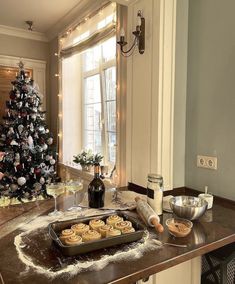 a christmas tree in the corner of a room with cookies and other food on it