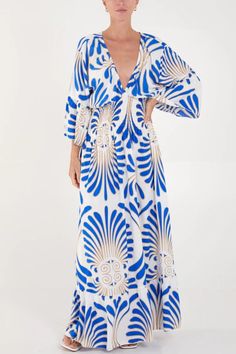 Make a statement with this oversized blue maxi dress, featuring a mesmerizing feather swirl print. Crafted from soft, breathable viscose, it provides luxurious comfort for all-day wear. The V-neckline and 3/4 sleeves add a touch of sophistication, while the flowing silhouette enhances your natural grace. Ideal for any occasion, from casual outings to special events, this dress effortlessly elevates your style with its vibrant design and relaxed fit. SPECS: Material: Viscose Color: Blue Fit: Over Flowy Blue Maxi Beach Dress, V-neck Beach Dress With Abstract Print, Blue Printed Maxi Dress For Beachwear, Blue Breezy Maxi Beach Dress, Blue Printed Maxi Beach Dress, Blue Printed Beachwear Dress, V-neck Dress With Abstract Print For Vacation, Blue Long Sleeve Maxi Dress For Vacation, Breezy Blue Maxi Dress For Vacation