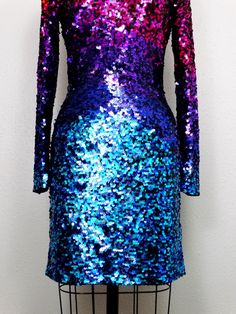 "Another colorful dress! Fully embellished with vibrant sequins all over in an ombre rainbow design. There's a bit of stretch in the material, so measurements are taken unstretched and stretched. It's in perfect condition! Size 4 measurements: Bust - 32/34\" Waist - 25/27\" Hips - 34/36\" Dress Length - 33\" Tag Size - 4 Size 8 measurements: Bust - 36/38\" Waist - 28/30\" Hips - 38/40\" Dress Length - 34\" Tag Size - 8 This dress comes from a pet-free and smoke-free home. If you would like more Fitted Disco Dress With Contrast Sequin, Iridescent Sequin Dress For Night Out, Fitted Multicolor Sequin Dress, Fitted Iridescent Evening Dress, Fitted Iridescent Dress For Evening, Iridescent Fitted Evening Dress, Iridescent Sequin Dresses For Party Season, Iridescent Fitted Dress For Party, Iridescent Fitted Party Dress