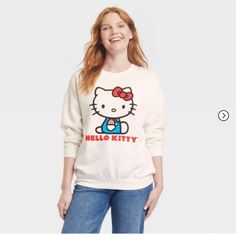 Snuggle Up In Style With Our Women's Hello Kitty Cozy Graphic Sweatshirt - White. Designed For Both Comfort And Fashion, It Has Ribbed Cuffs And A Round Neck. The Delightful Hello Kitty Print Adds A Dash Of Graphic Fun. Celebrate Your Love For Hello Kitty With The Soft, Women's Graphic Sweatshirt In White. Hello Kitty Cotton Sweatshirt In Kawaii Style, Cute Cotton Sweatshirt With Hello Kitty Print, Hello Kitty Print Crew Neck Cotton Sweatshirt, Trendy Hello Kitty Print Crew Neck Sweatshirt, Winter Cotton Tops With Hello Kitty Print, Cotton Crew Neck Sweatshirt With Hello Kitty Print, Fall Kawaii Style Cotton Top, Cute Hello Kitty Print Sweatshirt For Winter, Cute Hello Kitty Print Crew Neck Sweatshirt