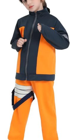 a young boy in an orange and black outfit with his hands on his hips, posing for the camera