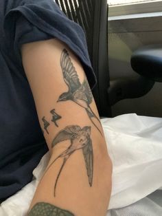 a person with a bird tattoo on their arm