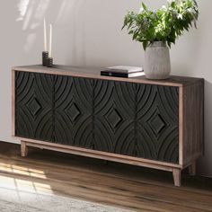 a plant is sitting on top of a wooden cabinet