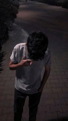 a man standing in the middle of a street at night