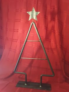 a metal christmas tree on a red background