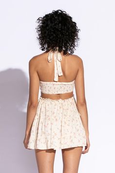 STYLE INFORMATION: Get your Texas boho vibes on in the Sundown Peach Floral Print Sundress!. Peach floral print Swiss dot fabric shapes this cute dress that has a halter V-neckline with tie straps, and a cutout waist.. The open back wraps around to the sides to create a cutout effect above the attached mini skirt. Ruffle trim and side ties decorate the cutout waist. DETAILS & CARE: Rayon/Polyester. Dry Clean. Imported. SHIPPING: We offer free shipping for all orders in the Continental US. Spring V-neck Halter Dress With Crisscross Straps, Spring Mini Dress With Wrap-around Straps, Summer Mini Dress With Wrap-around Spaghetti Straps, Summer Backless Halter Top With Crisscross Straps, Summer Halter Top With Crisscross Straps And Backless Design, Summer Halter Dress With Adjustable Straps For Spring, Spring/summer Halter Dress With Adjustable Straps, Spring Summer Halter Dress With Adjustable Straps, Spring Sundress Halter Dress With Adjustable Straps