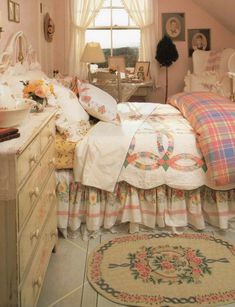 a bed room with a neatly made bed next to a dresser and a large window