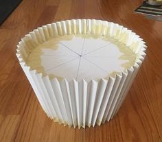 a white cupcake liner sitting on top of a wooden table