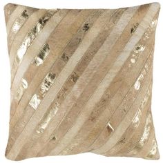 a gold and white pillow with stripes on it's side, in front of a white background