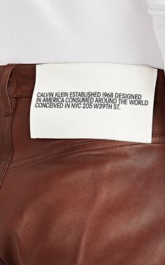 a label on the back of a brown leather pants