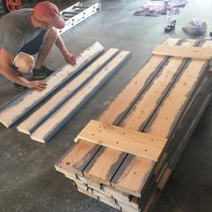 a man is working on some wood planks