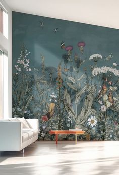 a living room with green walls and flowers on the wall