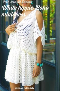 a woman standing in front of a window wearing a white crochet dress