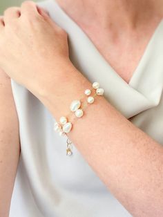 Make a classic and elegant statement with this multi-layered mixed pearl bracelet. Two handcrafted strands of differently shaped and sized pearls create a versatile accessory suitable for weddings, brunches, work, and more. The lobster clasp and extender ensure a secure and adjustable fit. Length: 7.5 inches plus 1.5-inch extender Materials: gold fill, cultured freshwater pearls GIFTING ~ Jewelry gift box included. ~ I am happy to ship directly to the recipient.  Enter their address during checkout. ~ If you would like a gift note included in the package, please leave the text of the note in the "Add a note to Marsh Creek Jewelry" message box at checkout. FREE SHIPPING ~ Orders ship within 2 business days. ~ Free shipping is First Class ~ Priority Mail and Express Shipping upgrades are ava Elegant Pearl Drop Bracelet For Party, Baroque Pearl Bracelets For Wedding, Baroque Pearl Wedding Bracelets, Wedding Baroque Pearl Chain Bracelet, Pearl White Bracelets With Pearl Drop For Party, Pearl White Bracelet With Pearl Drop For Party, Elegant Bracelet With Baroque Pearl Charm, Elegant Baroque Pearl Bracelet Jewelry, Elegant Baroque Pearl Bracelet For Wedding