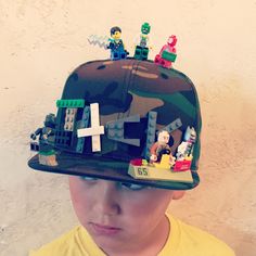 a young boy wearing a lego hat