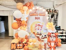 there are many balloons and decorations on the floor in front of a sign that says cute ann bot