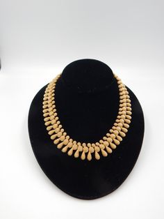 Gorgeous textured gold-plated assorted shapes of ovals, teardrops and round circle come together to create an enchanting mini-bib Monet necklace. Simplistic elegance. The perfect necklace for that night out on the town or something to dress up jeans. Condition is very good. The gold-plating is intact. The Monet hang tag is located at the adjustable hook closure. Unclasp the necklace measures 16 3/4 inches with a drop of 3/4 inches. Please look at the photos as they provide the visual description Gold Teardrop Evening Necklaces, Vintage Gold Drop Necklace, Gold Drop Vintage Necklace, Vintage Gold Teardrop Necklace, Cos Jewellery, Dress Up Jeans, Monet Jewelry, Vintage Monet, Bib Necklaces