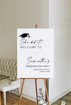 a welcome sign for someone's graduation party in front of a couch and table