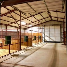 the inside of a building with lots of wood and metal fencing on it's sides