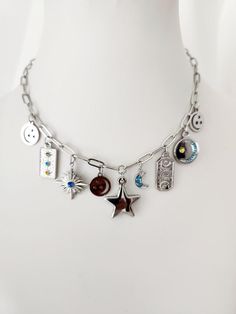 Multi Charm Silver Necklace | Stars, Sun and Moon Necklace | Stainless Steel | Celestial Necklace | Gift for Her | Bohemian and Trendy Necklace | Cosmic and Tarot Necklace | Necklace for Witches Immerse yourself in the magic of the cosmos with this Multi Charm Silver Necklace. Designed for lovers of the night sky, this stainless steel necklace features star, sun and moon charms, capturing the essence of the universe in a stylish and meaningful piece of jewelry. Perfect as a gift for her, this ce Celestial Dangle Necklace With Star Charm, Celestial Pendant Charm Necklace In Metal, Celestial Pendant Charm Necklace, Celestial Metal Pendant Charm Necklaces, Metal Star Charm Pendant Necklace, Silver Celestial Charm Necklaces For Everyday, Silver Celestial Charm Necklace For Everyday, Silver Celestial Charm Necklace With Star Charm, Cosmic Necklace